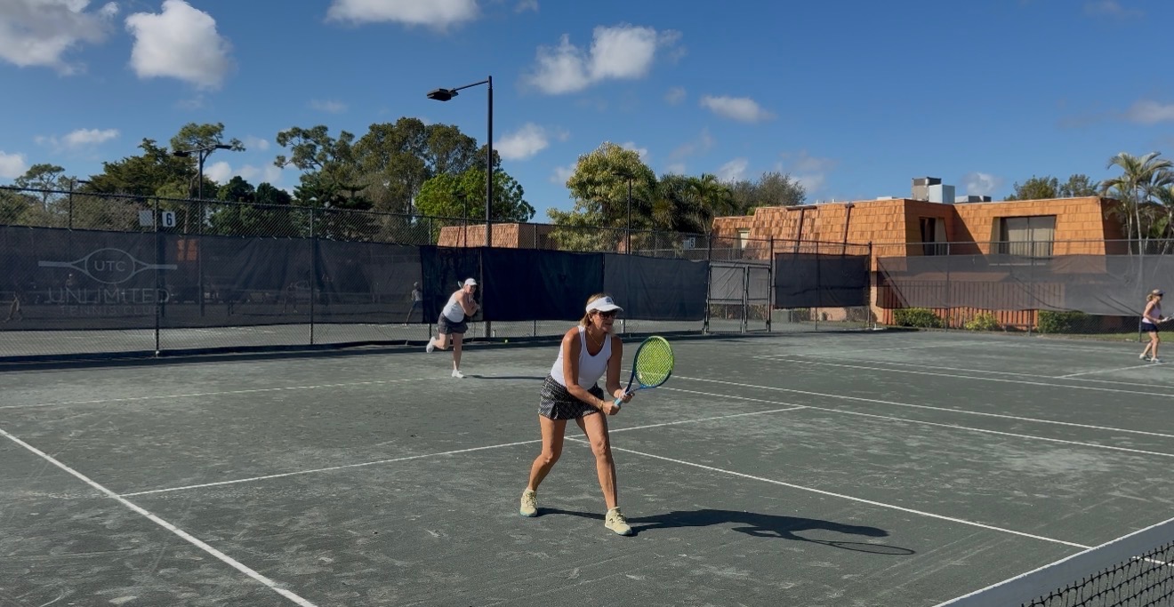 Unlimited Tennis Club players celebrating after a round robin on a Har-Tru court in Fort Myers