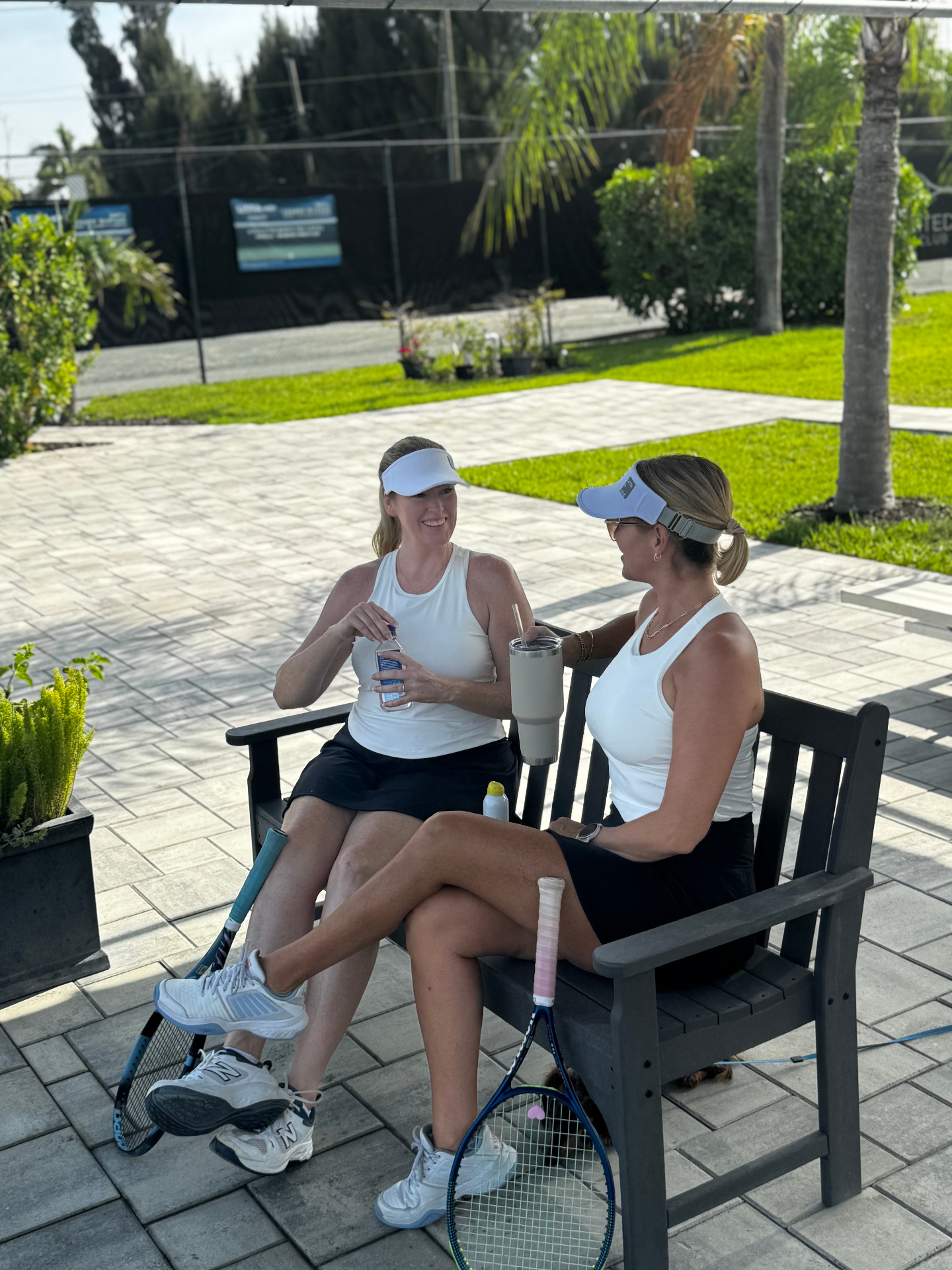 Two Unlimited Tennis Club members talking and relaxing after tennis in Fort Myers